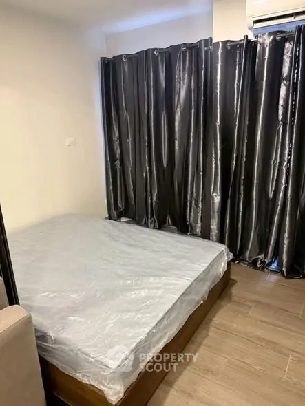 Cozy bedroom with modern decor and sleek curtains, perfect for urban living.