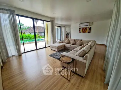 Spacious living room with pool view and modern decor
