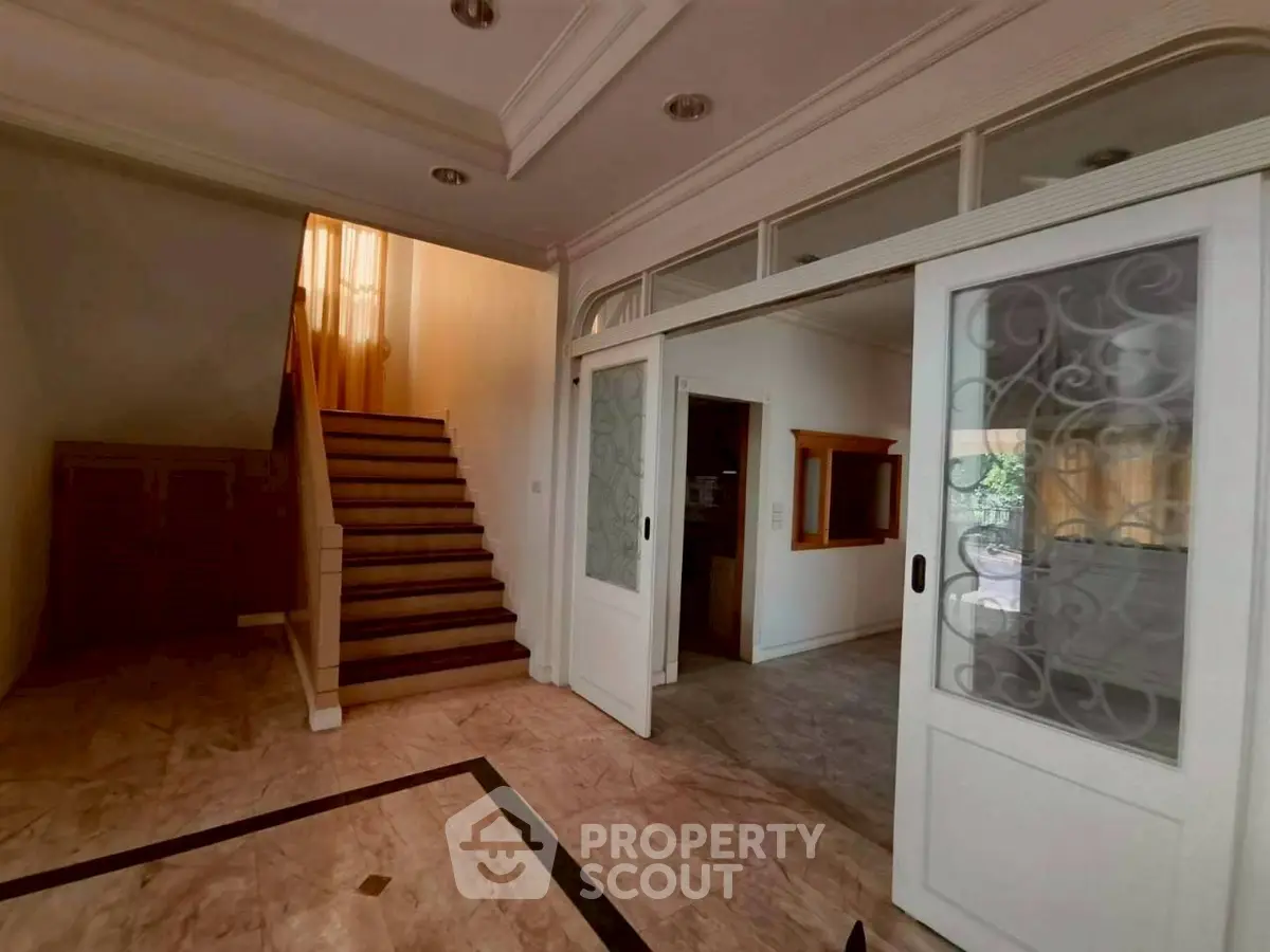 Elegant entrance with marble flooring and stylish sliding doors