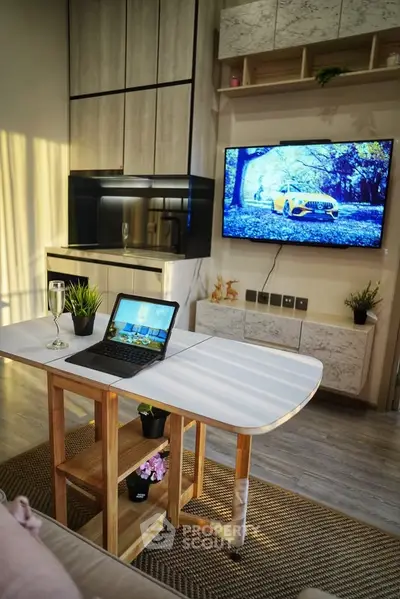 Modern living room with stylish furniture, wall-mounted TV, and natural light.