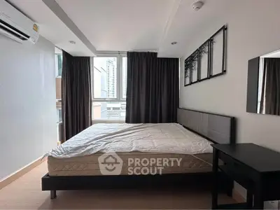 Modern bedroom with large window and stylish decor in urban apartment
