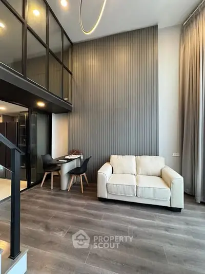 Modern loft-style living room with high ceilings and elegant decor