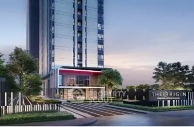Modern high-rise building exterior with landscaped entrance and sleek architectural design.