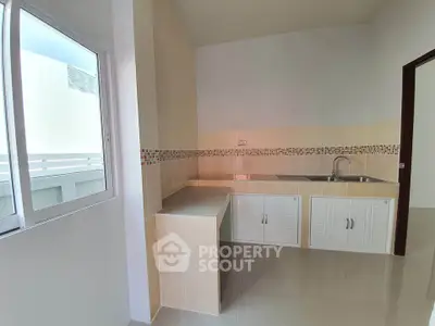 Modern kitchen with sleek countertops and ample natural light
