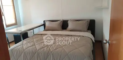 Cozy bedroom with modern decor and natural light, perfect for relaxation and comfort.