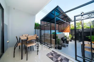 Charming outdoor patio with dining set and BBQ area, perfect for entertaining in a modern home.