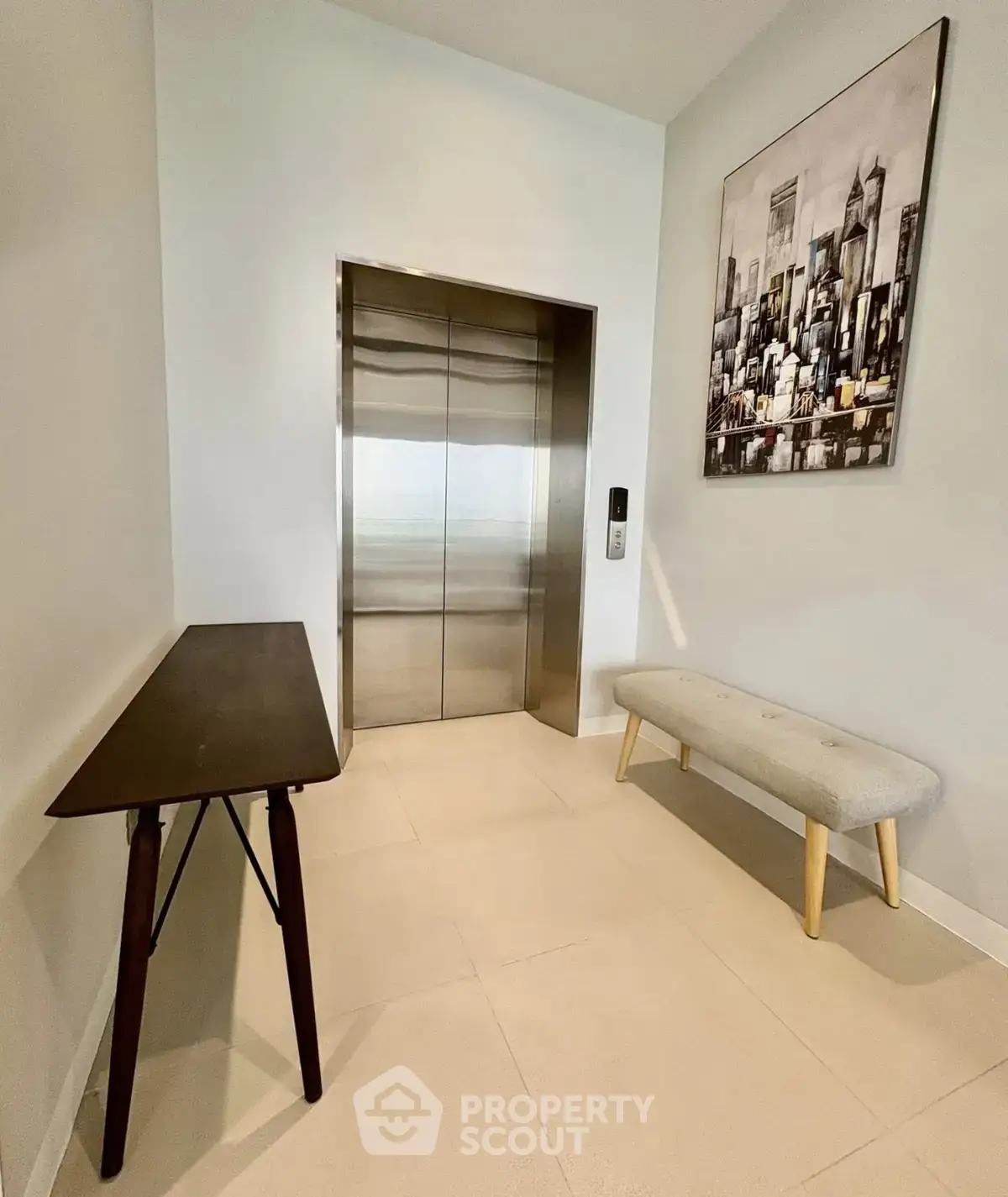 Modern building elevator lobby with stylish decor and seating area.