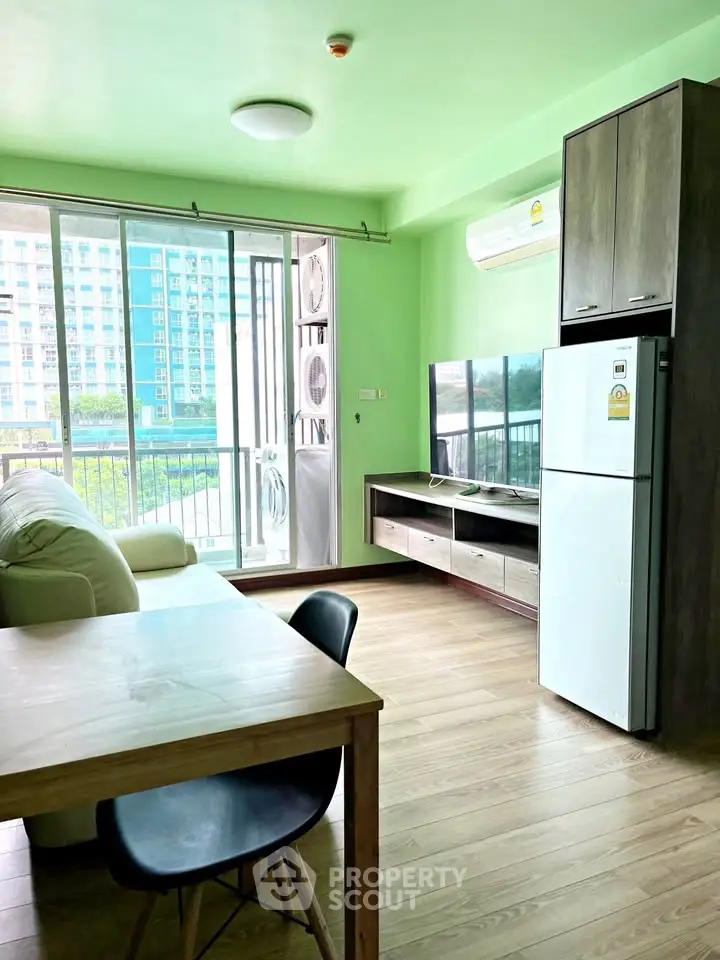Bright living room with modern furniture and large windows in a stylish apartment.