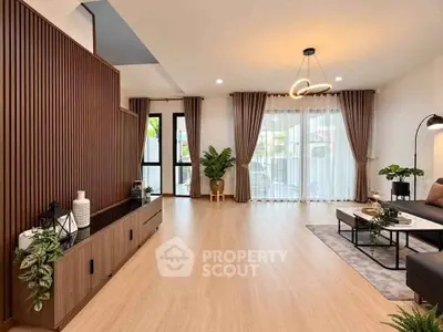 Spacious modern living room with elegant decor and large windows for natural light.