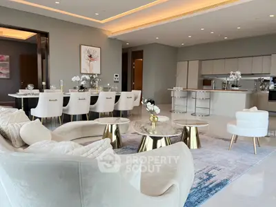 Luxurious open-plan living and dining area with elegant decor and modern kitchen.