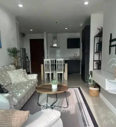 Modern living room with stylish decor and open kitchen layout in a contemporary apartment.