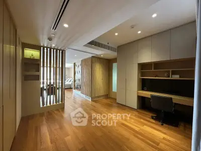 Spacious modern study room with wooden flooring and built-in desk