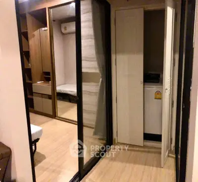 Modern apartment interior with mirrored closet and washing machine
