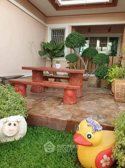 Charming garden patio with unique wooden seating and playful animal decor.