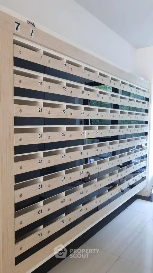 Modern apartment building mailboxes with sleek design and numbered slots.