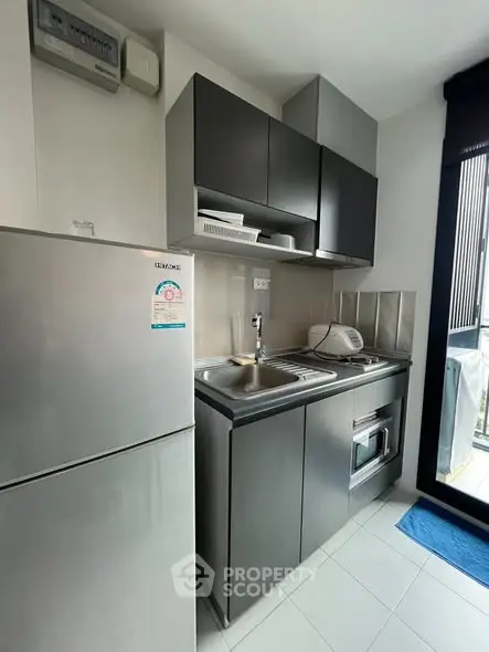 Modern compact kitchen with sleek cabinets and stainless steel appliances