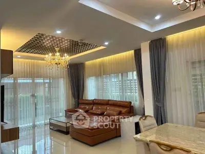 Luxurious living room with elegant chandelier and spacious leather sofa in modern apartment.
