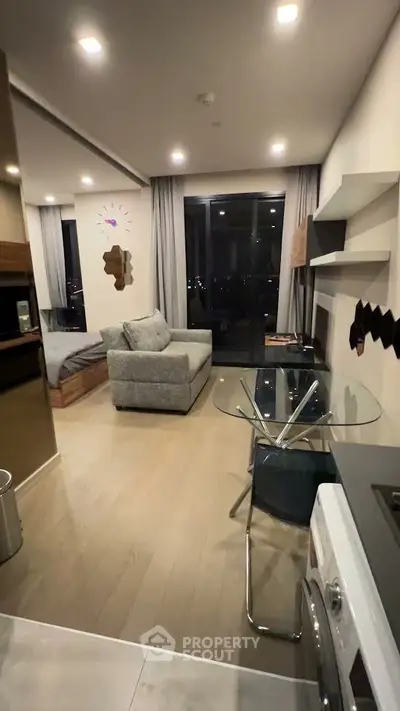 Modern studio apartment with open layout, featuring a cozy living area and stylish kitchen.