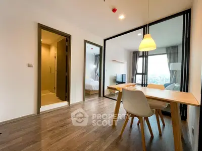 Modern apartment interior with open dining area and view into bedroom
