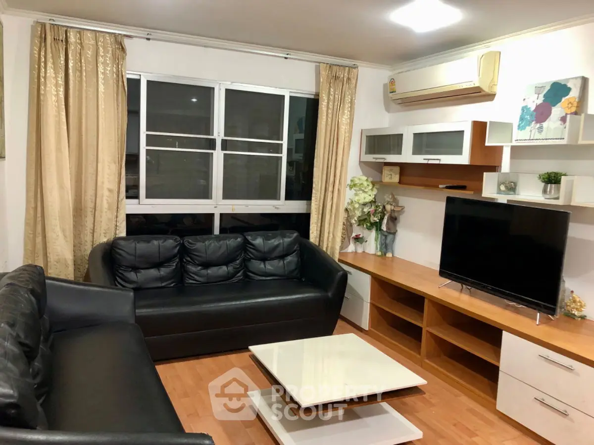 Cozy living room with black leather sofas and modern decor