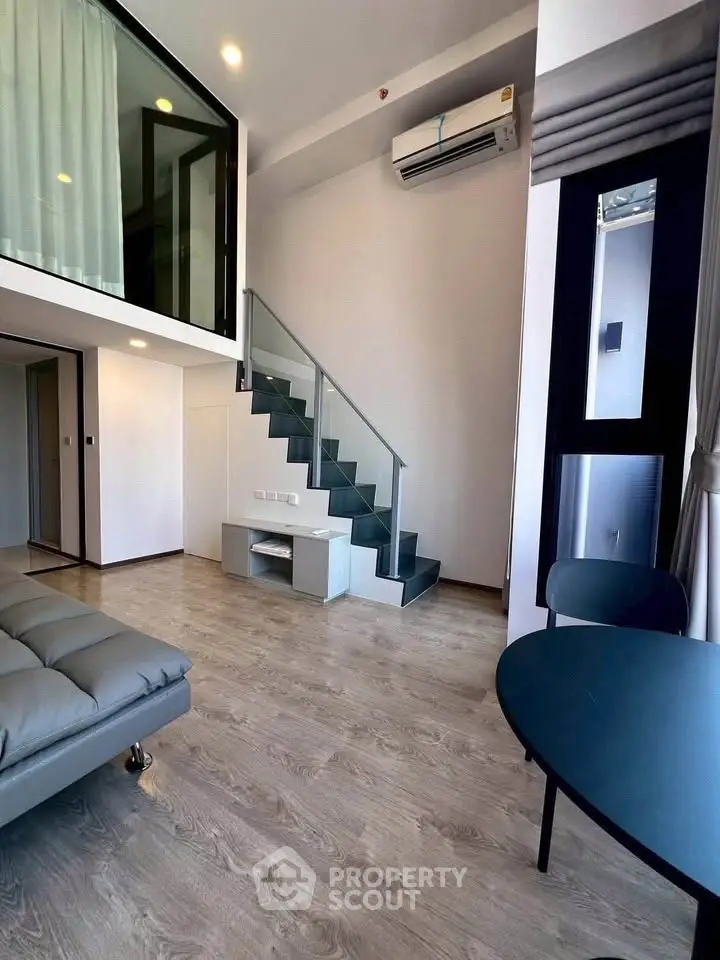 Modern duplex apartment with stylish staircase and sleek interior design