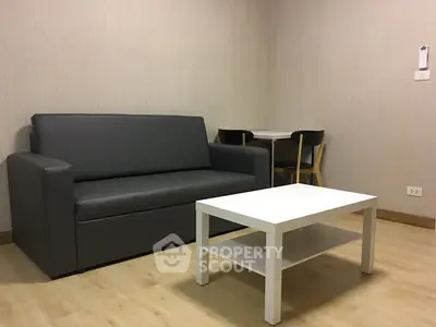 Modern living room with sleek gray sofa and minimalist white coffee table