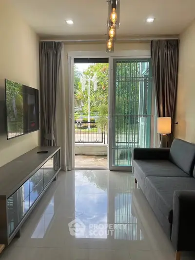 Modern living room with sleek furniture and large window offering garden view