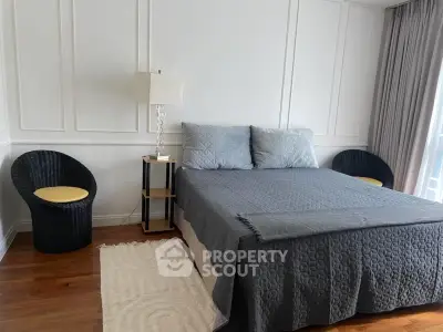 Charming bedroom with cozy bed, elegant decor, and natural light for a serene living experience.