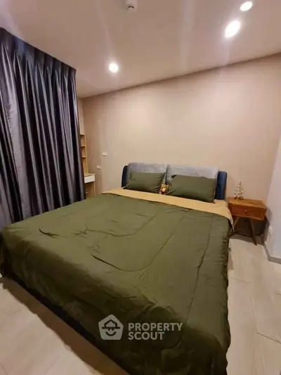 Cozy bedroom with elegant decor and soft lighting, featuring a comfortable bed and stylish curtains.