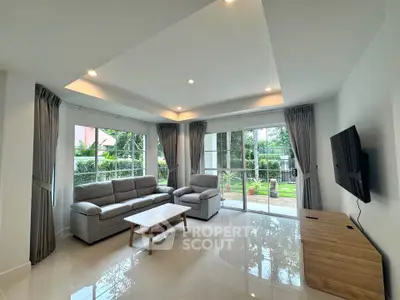 Spacious living room with modern furniture and garden view, perfect for relaxation.