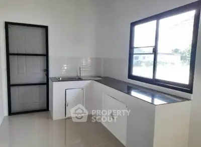 Modern kitchen with sleek countertops and ample natural light
