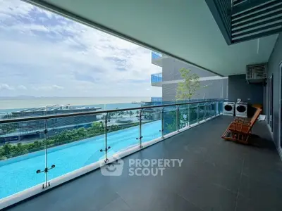 Luxurious balcony with stunning ocean view and pool access, perfect for relaxation.
