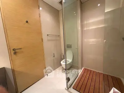 Modern bathroom with glass shower and wooden accents