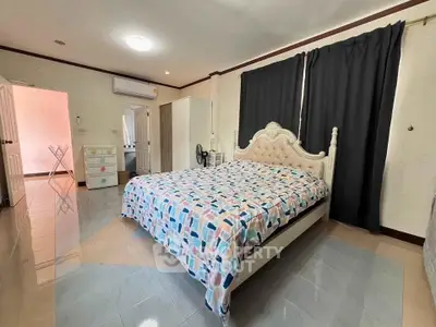 Spacious bedroom with elegant bed and modern decor in a cozy home.