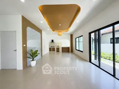 Spacious modern living room with open layout and large windows for natural light.