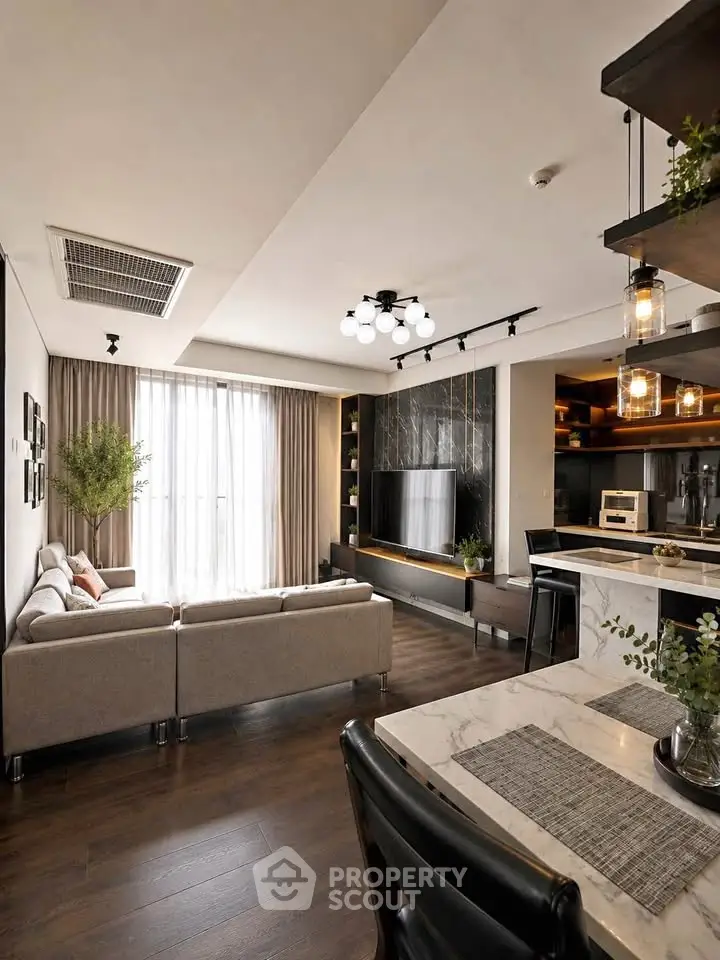 Modern living room with stylish decor, open layout, and natural light from large windows.