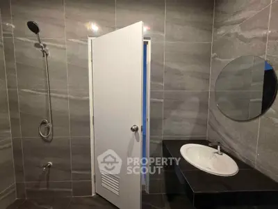 Modern bathroom with sleek gray tiles and minimalist fixtures