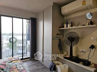 Cozy bedroom with balcony view and modern air conditioning