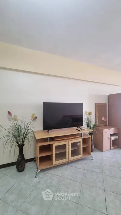 Spacious living room with modern TV stand and decorative plants