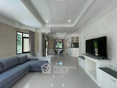 Spacious modern living room with elegant decor and large windows