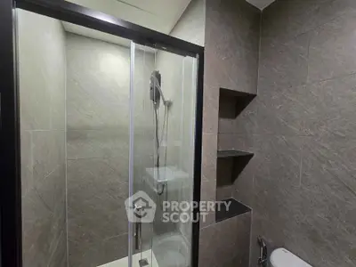 Modern bathroom with sleek shower enclosure and elegant tile design