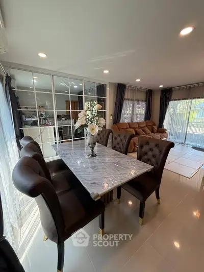 Luxurious living room with elegant dining area and plush seating, perfect for entertaining guests.