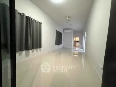 Spacious unfurnished room with glossy floors and large windows, ideal for customization.