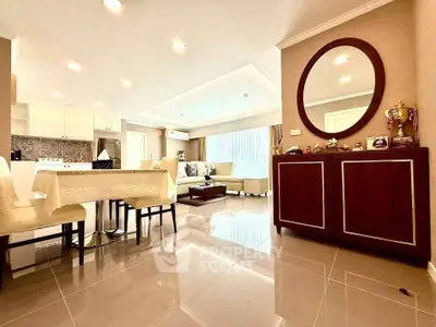 Spacious open-plan living room with elegant dining area and modern kitchen.