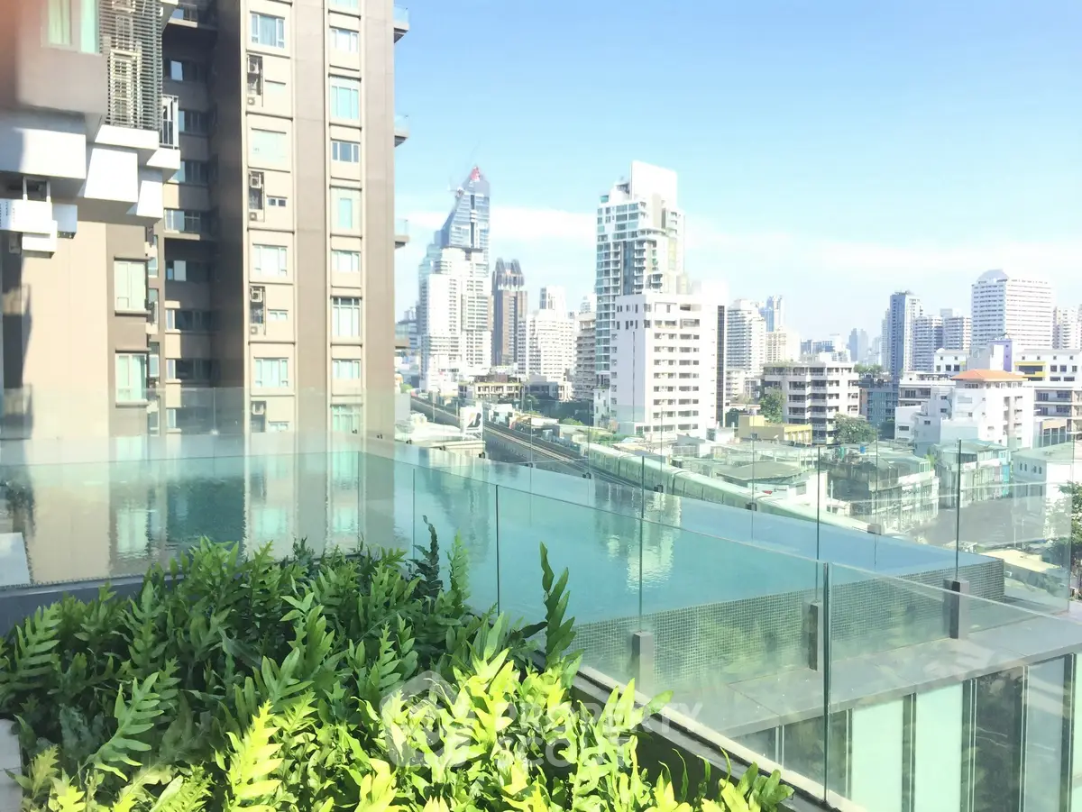 Stunning rooftop pool with panoramic city views in modern urban setting.