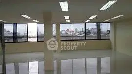 Spacious office space with large windows and city view