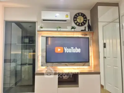 Modern living room with stylish TV setup and air conditioning unit, perfect for entertainment.