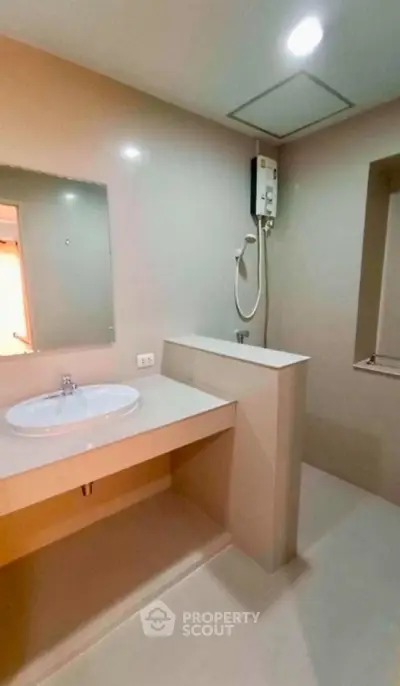 Modern minimalist bathroom with sleek design and built-in shower heater