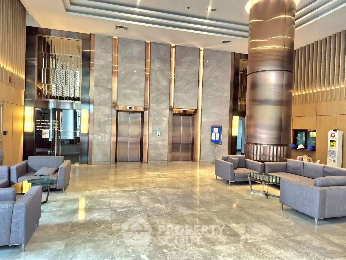 Luxurious modern building lobby with elegant elevators and stylish seating area.