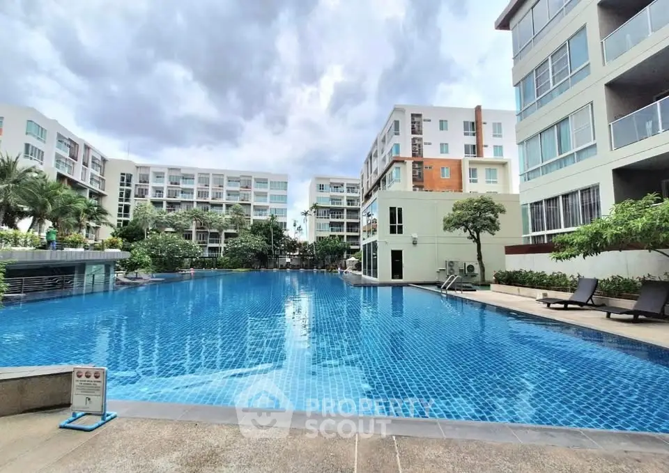 Luxurious condominium with a stunning pool and modern architecture, perfect for upscale living.